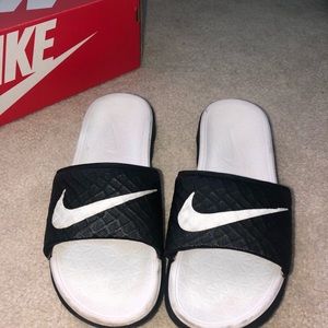 White and black nike slides